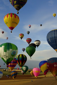 Multiple balloons taking off at balloon meeting